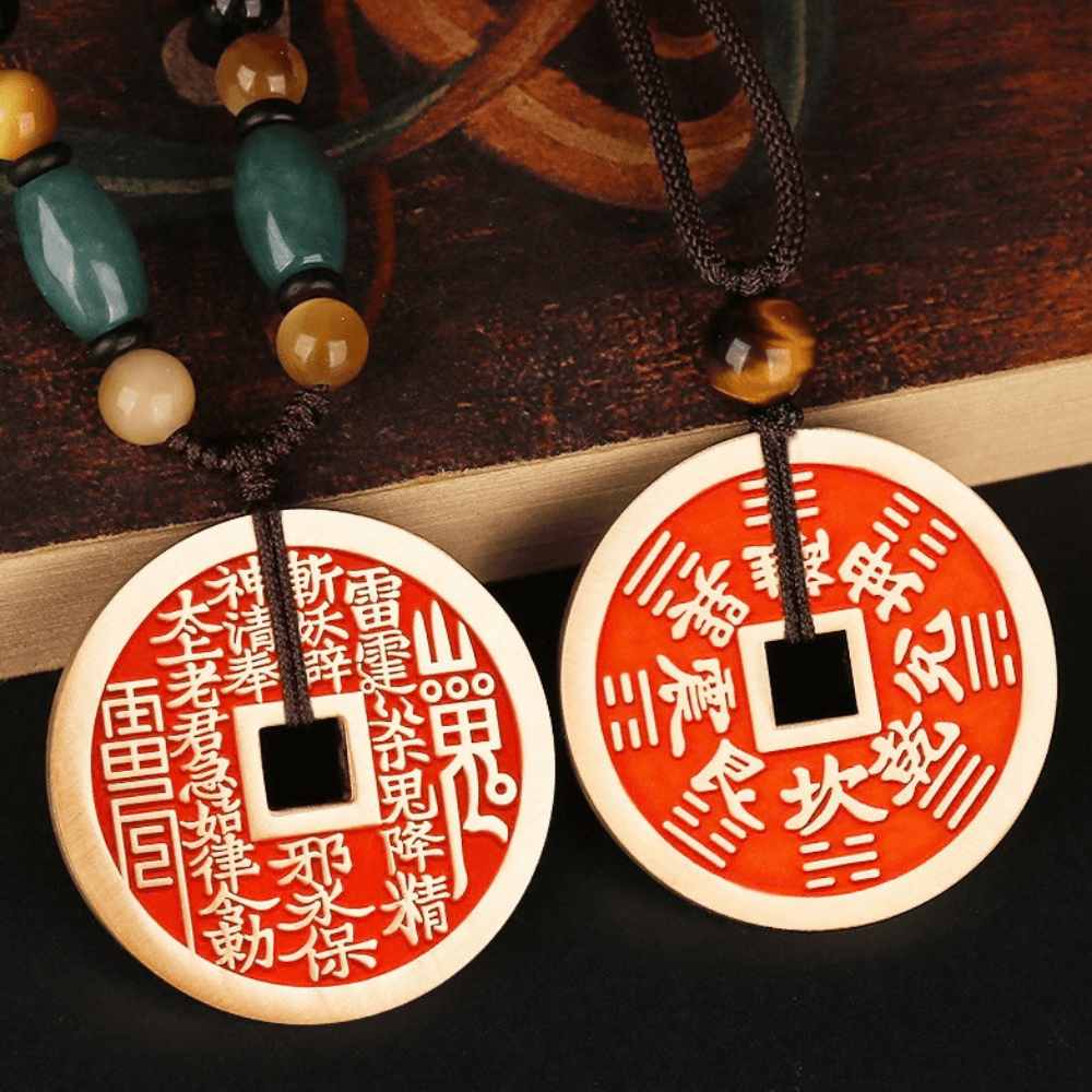 Feng Shui hanging ornament featuring cinnabar amulet coin and Bagua symbol