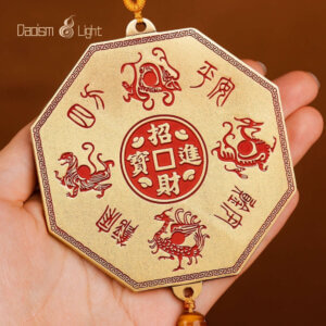Close-up of octagonal brass Tian Guan plaque with genuine cinnabar filling