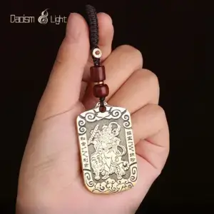 Solid brass Zhao Gongming tiger token pendant shown in hand